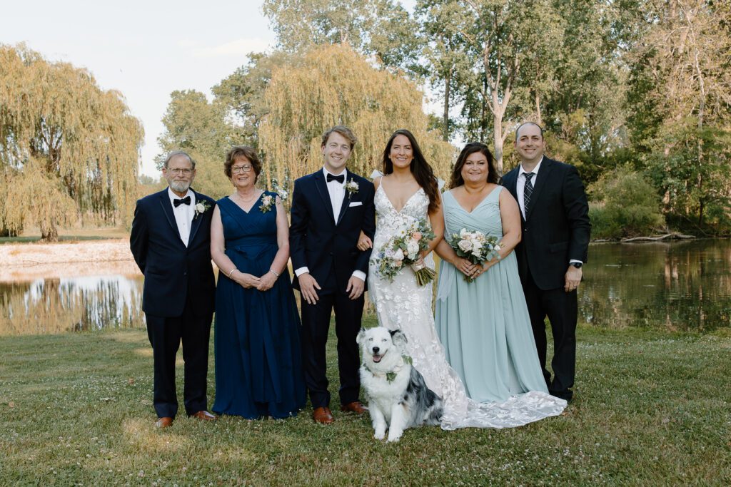 A dog included in wedding portraits with the bride and groom's family