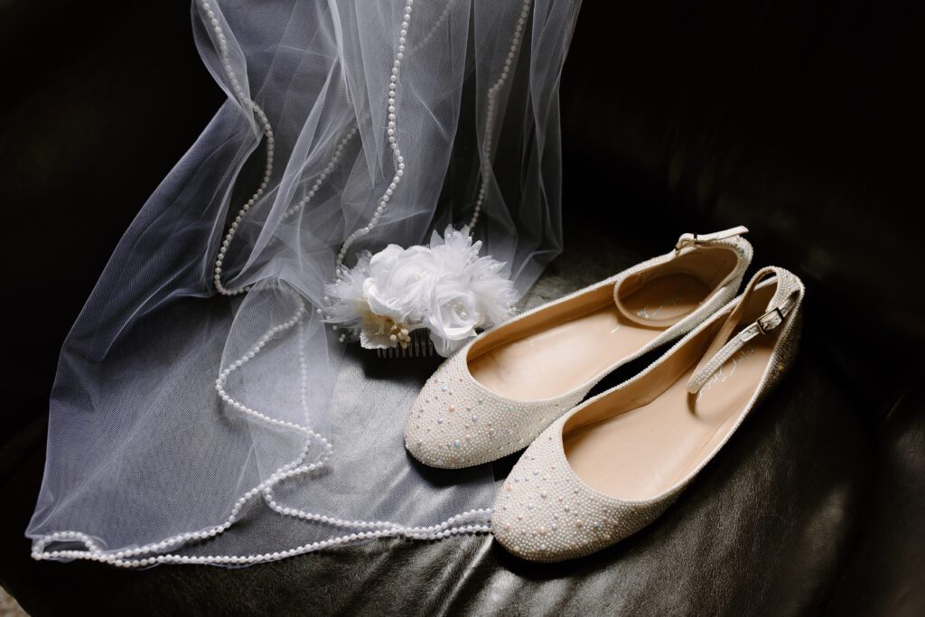 Wedding detail photos featuring shoes, veil, and hair piece