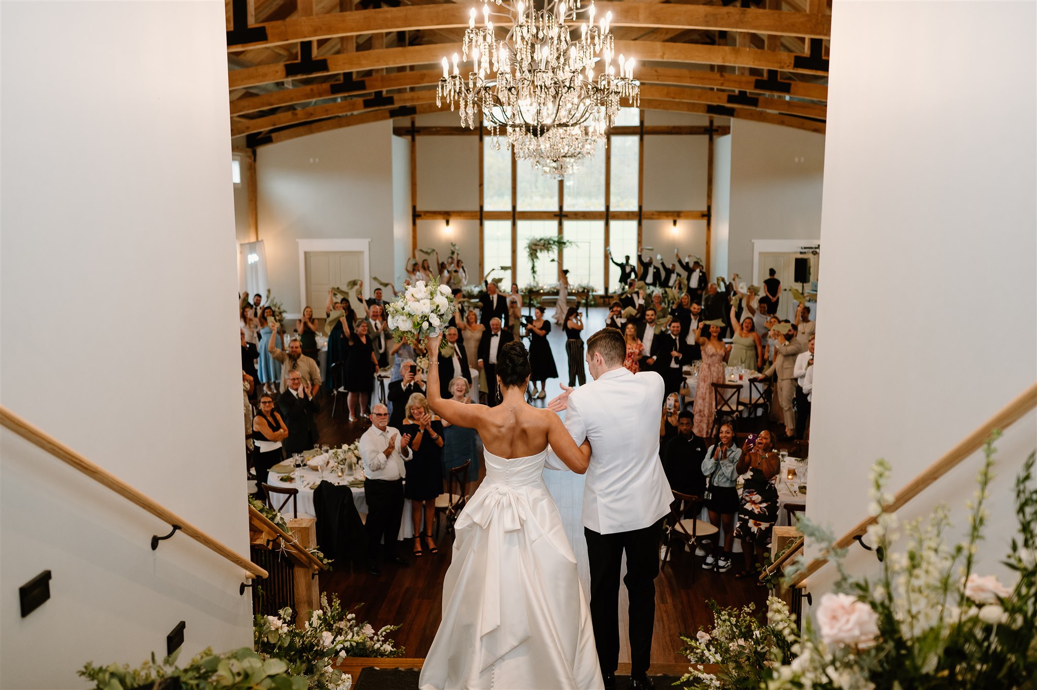 Wedding reception at Birchwood meadow showing the couple's entrance down the grand staircase